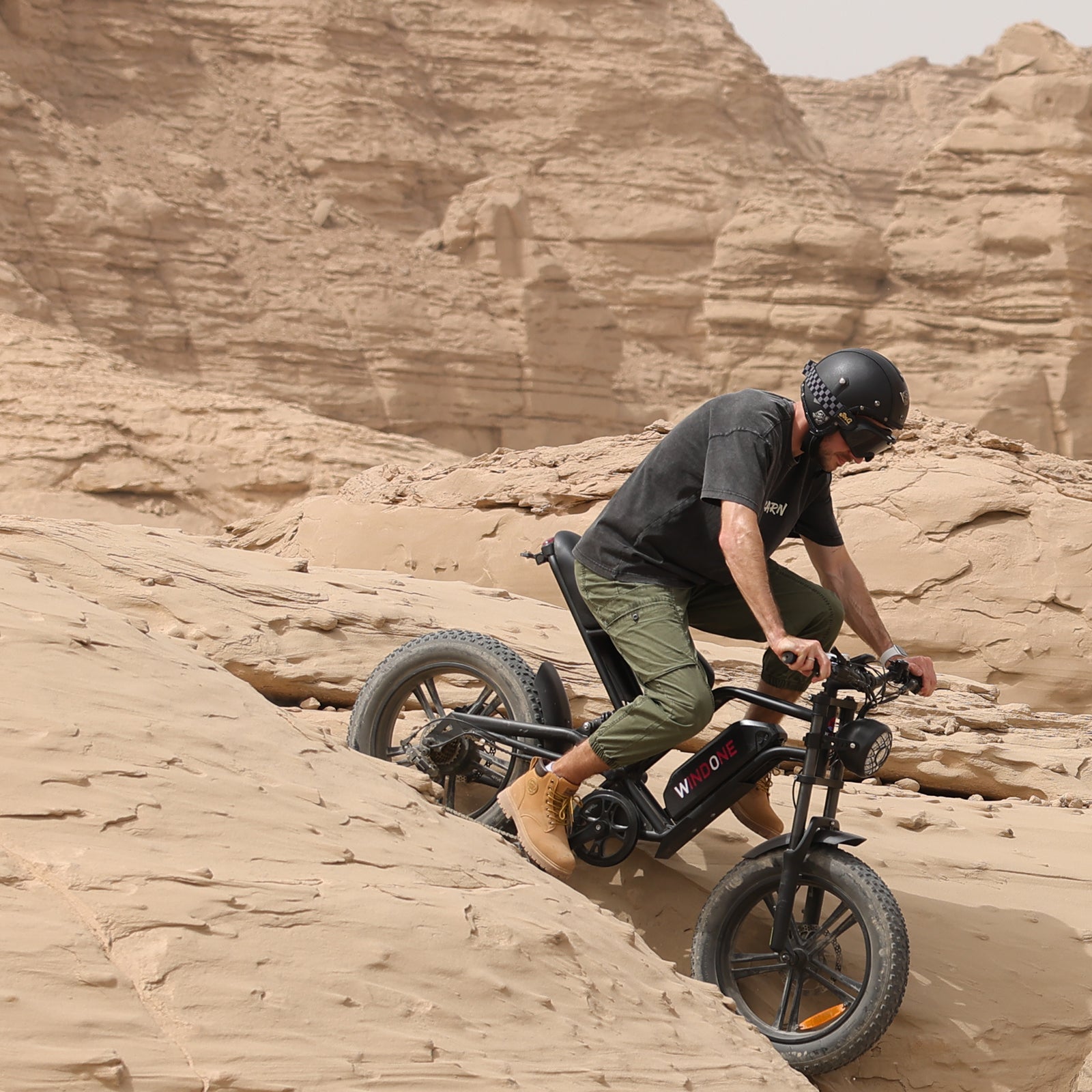 A man rides a Windone E2 Fat Tire Electric Bike in the desert