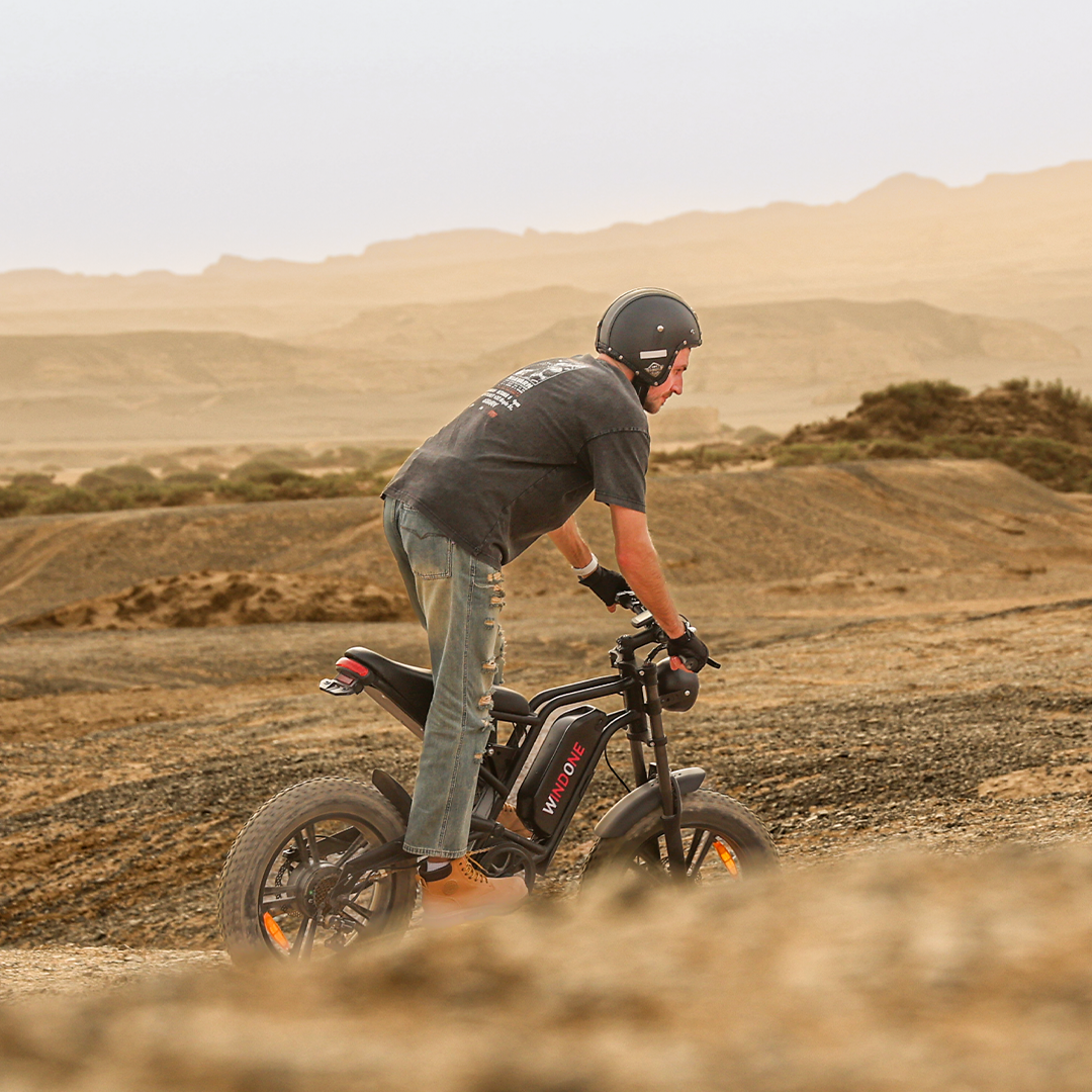 A man rides a Windone E2 Fat Tire Electric Bike in the desert