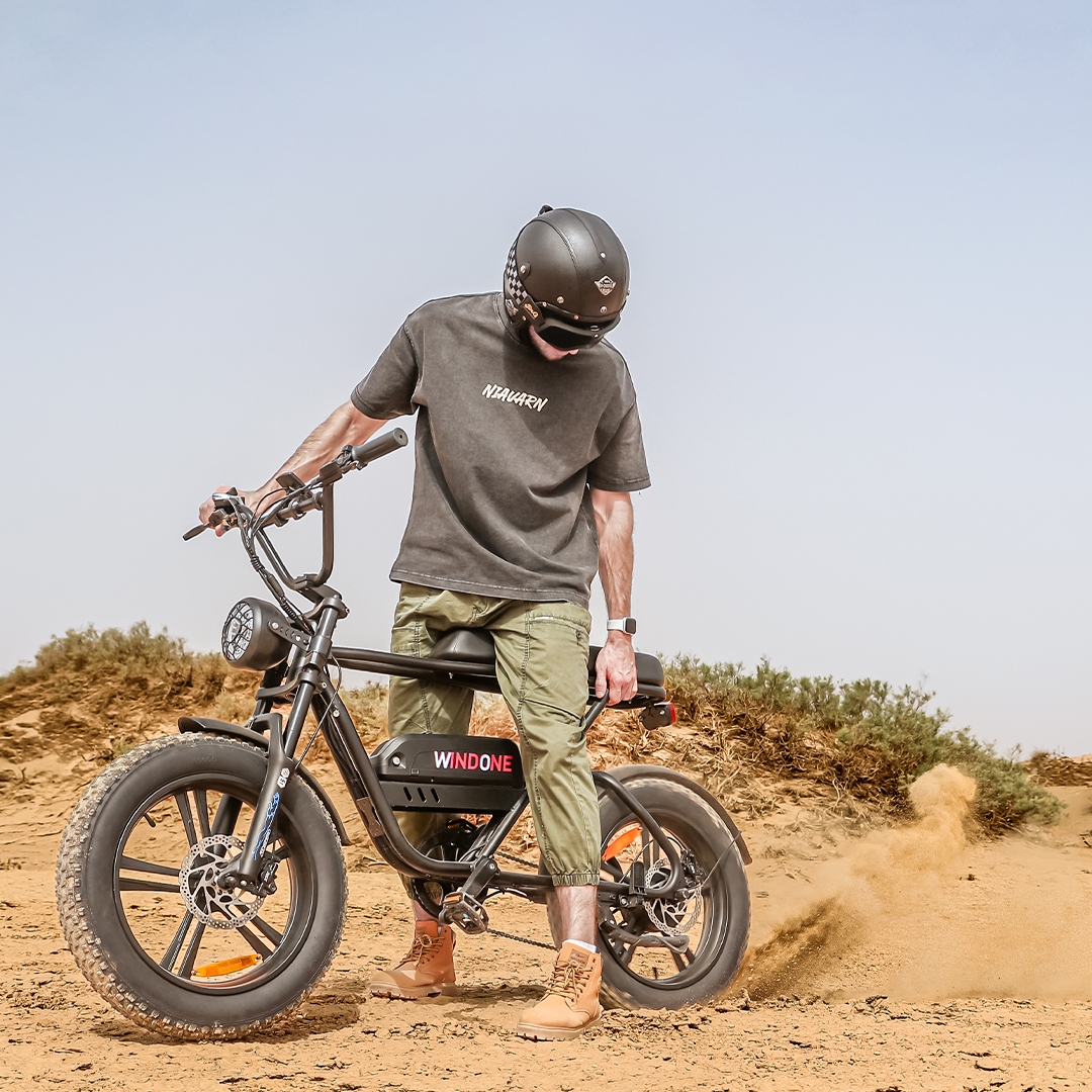 A man rides a Windone K2 Fat Tire Electric Bike on gravel land